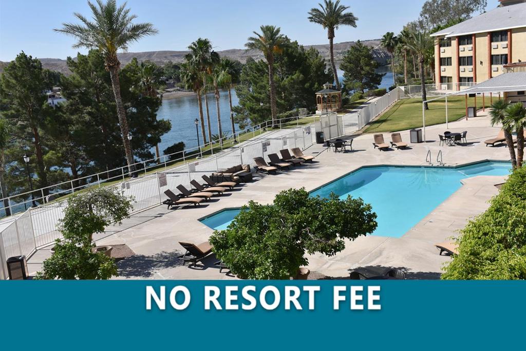 a resort with a no resort fee sign next to a swimming pool at Laughlin River Lodge in Laughlin