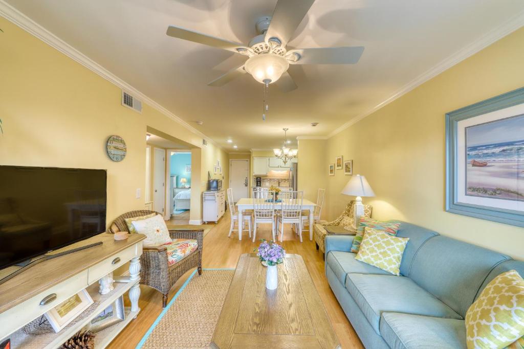 a living room with a blue couch and a tv at Oceanside 306-B in Isle of Palms