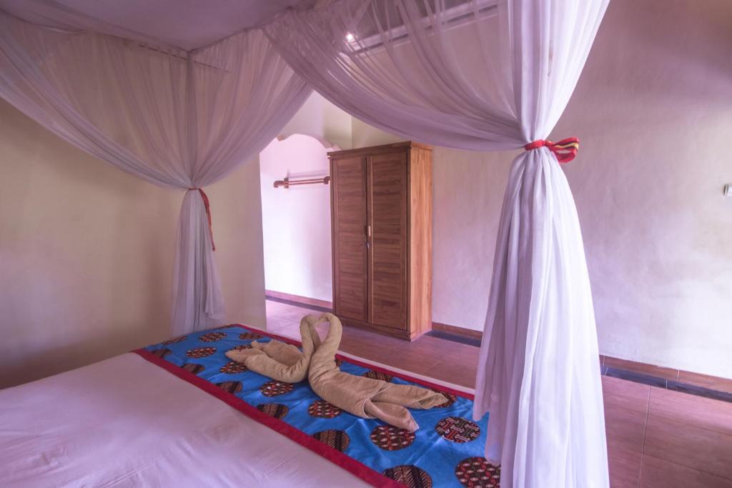 Postel nebo postele na pokoji v ubytování Trijaya Guest House Pemuteran