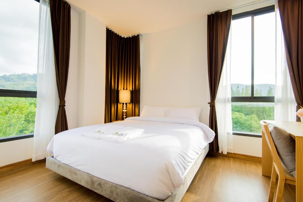 Postel nebo postele na pokoji v ubytování Hill Myna Condotel Official Account