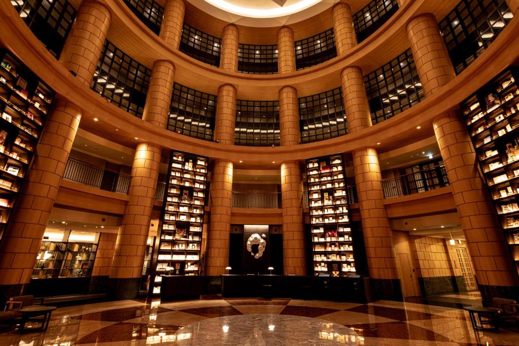 a library with a large building with many books at THE BASICS FUKUOKA in Fukuoka