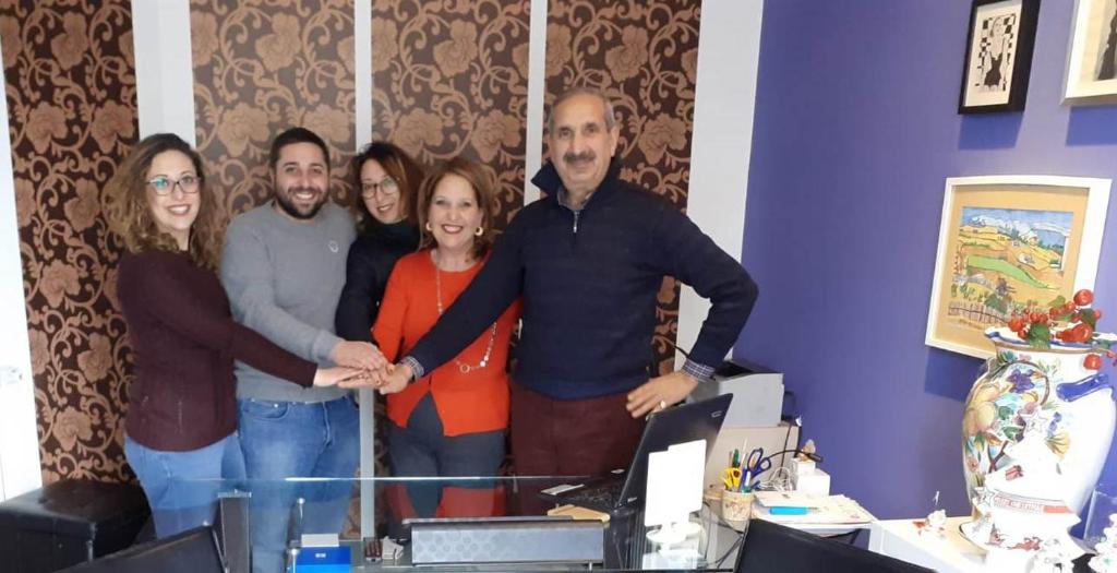 a group of people posing for a picture in a room at Casale Villa Rainò in Gangi