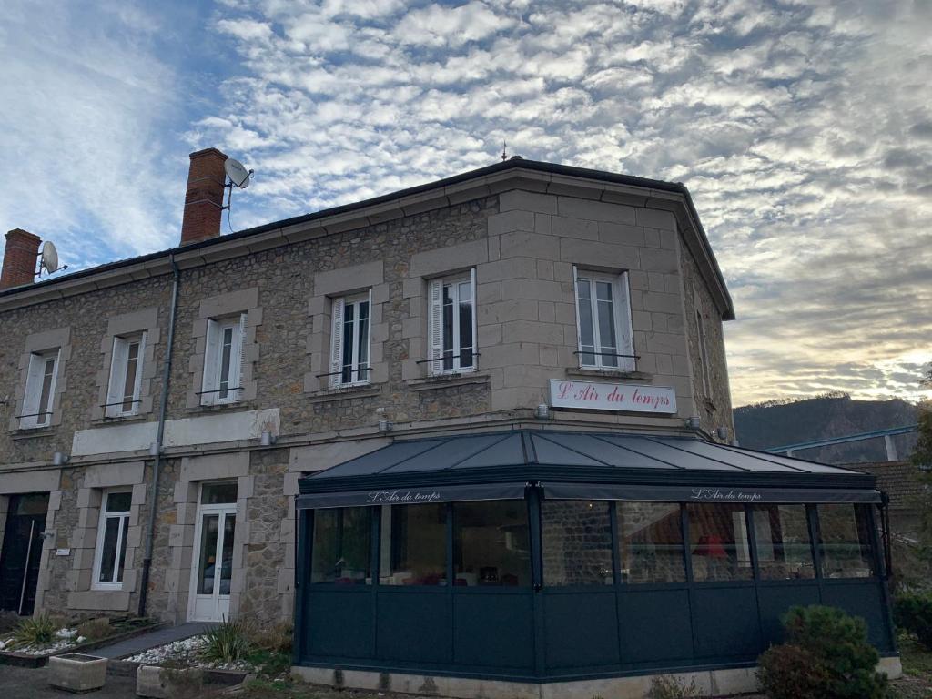 a building with a sign on the front of it at L’air du temps in Beauzac