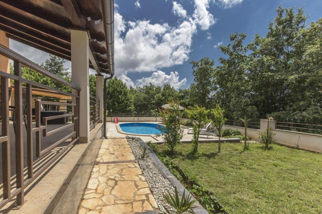 a backyard with a swimming pool and a house at Luxury experience in Villa Kacana with heated pool and Play station 4 in Vodnjan