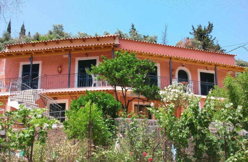 a house with a fence in front of it at Korina Studios in Paleokastritsa