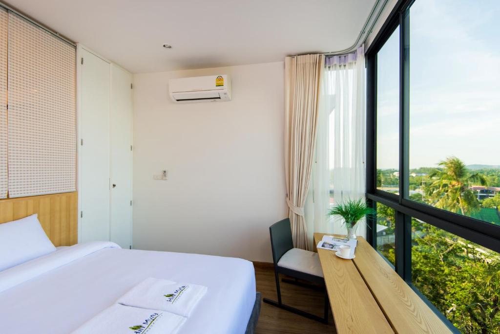 Postel nebo postele na pokoji v ubytování Hill Myna Condotel Official Account