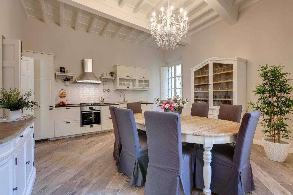 a kitchen with a dining room table and chairs at Lambert Apartment in Florence