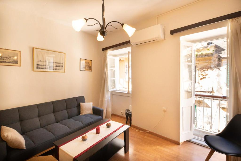 a living room with a couch and a table at Andrew's Old Town Apartment in Corfu