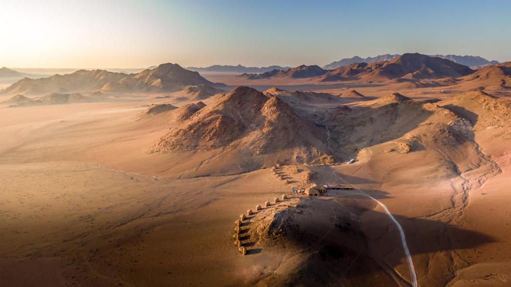an aerial view of a desert with mountains at Desert Hills Lodge in Sesriem