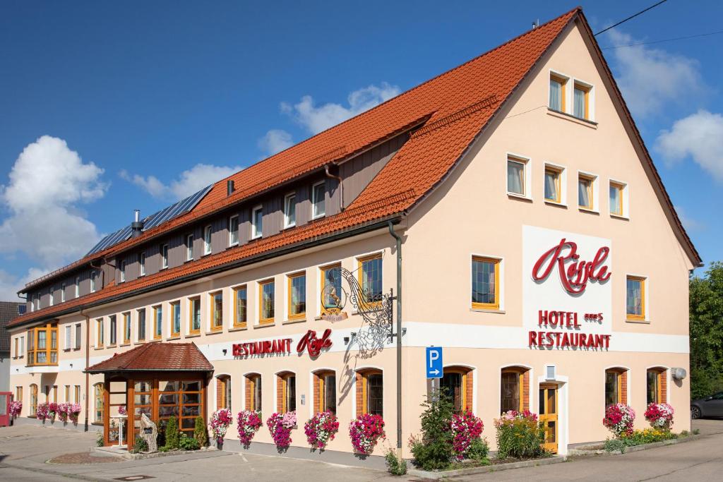a large white building with a red roof at Landgasthof Hotel Rössle in Steinenkirch