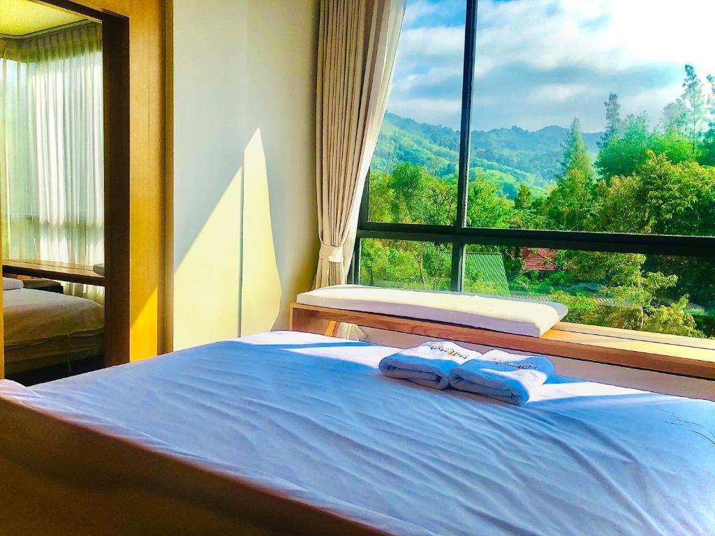 Postel nebo postele na pokoji v ubytování Hill Myna Condotel Official Account