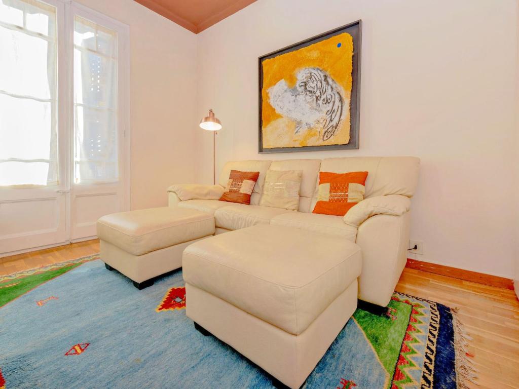 a living room with a couch and a table at Apartment Eixample Esquerre Arago Rocafort by Interhome in Barcelona