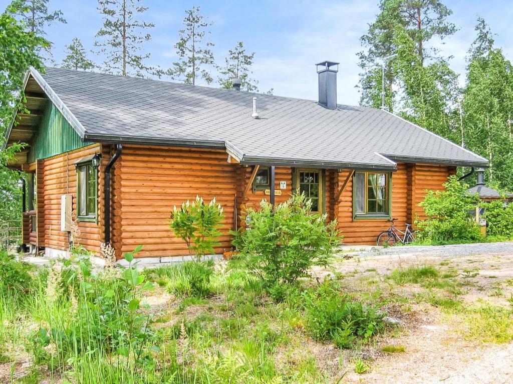 a wooden house with a green roof at Holiday Home Kallionnenä by Interhome in Mäkikylä