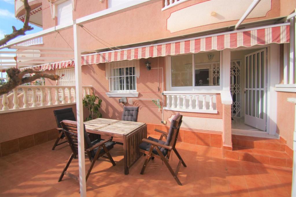 a table and chairs on the balcony of a house at Apartamento CasaTuris en Playa Lisa Santa Pola SP101 in Santa Pola