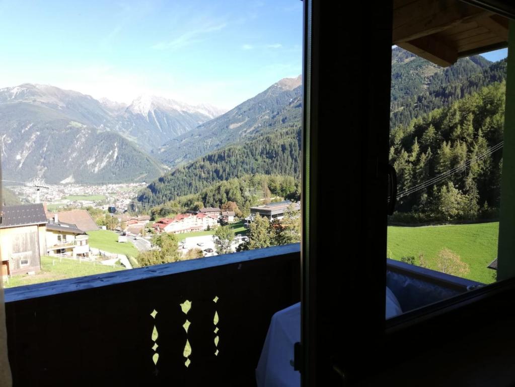 a view from a window of a mountain range at Landhaus Stöckl in Finkenberg