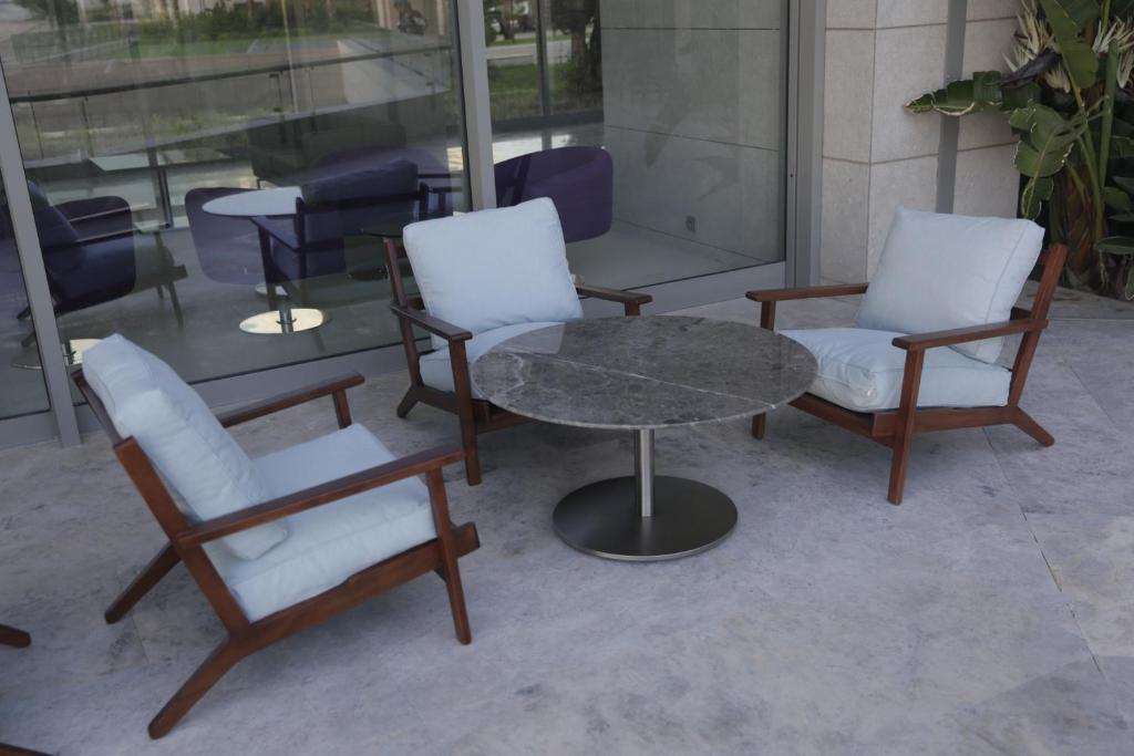 two chairs and a table and a table and chairs at ON'LIVE HOTEL in Çeşme