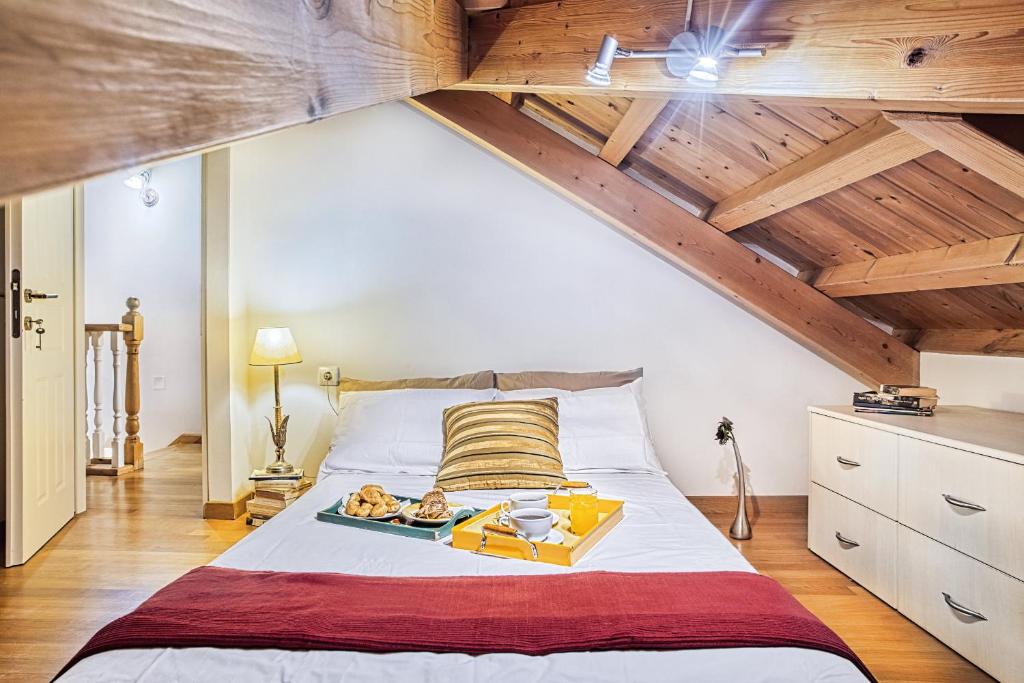 a bedroom with a large bed with wooden ceilings at CASA MIRKA Corfu Petite Maisonette in Anemómylos