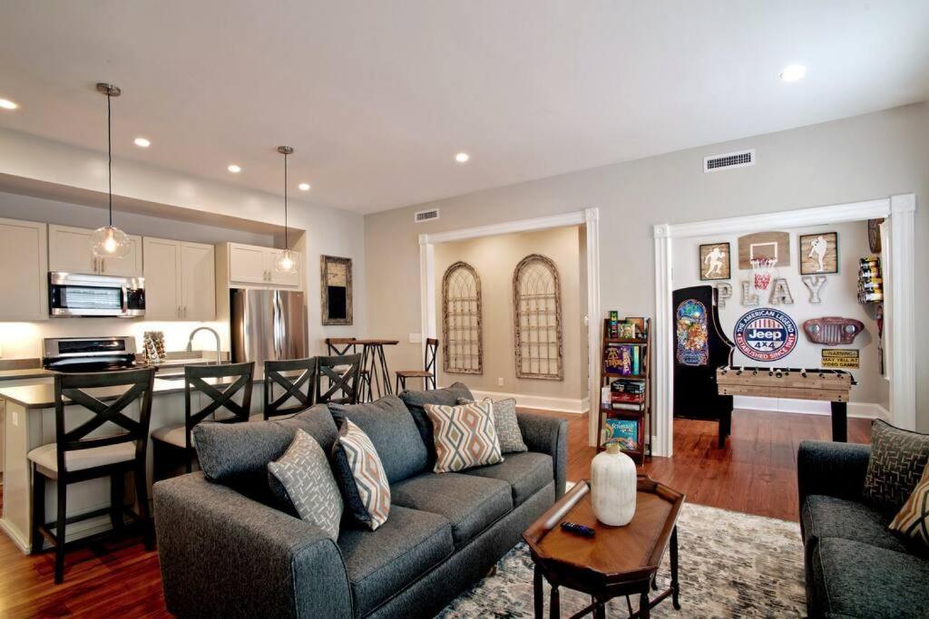 a living room with a couch and a kitchen at Newly Renovated 4 bed 3 bath and 2 Parking Spots in Savannah