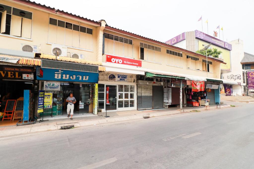 a street with many shops on the side of the road at OYO 717 My Space Hostel in Chiang Mai