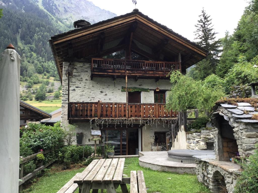 a building with a balcony on the side of it at Chalet d'en Haut Luxury and Charm in a Savoyard chalet in Les Masures