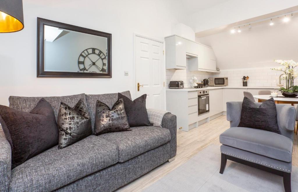 a living room with a couch and a chair at Minster's Reach York city centre Apartments in York