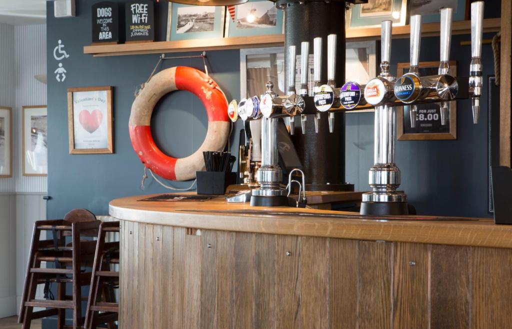 a bar with an orange life preserver on the wall at Seacroft in Holyhead