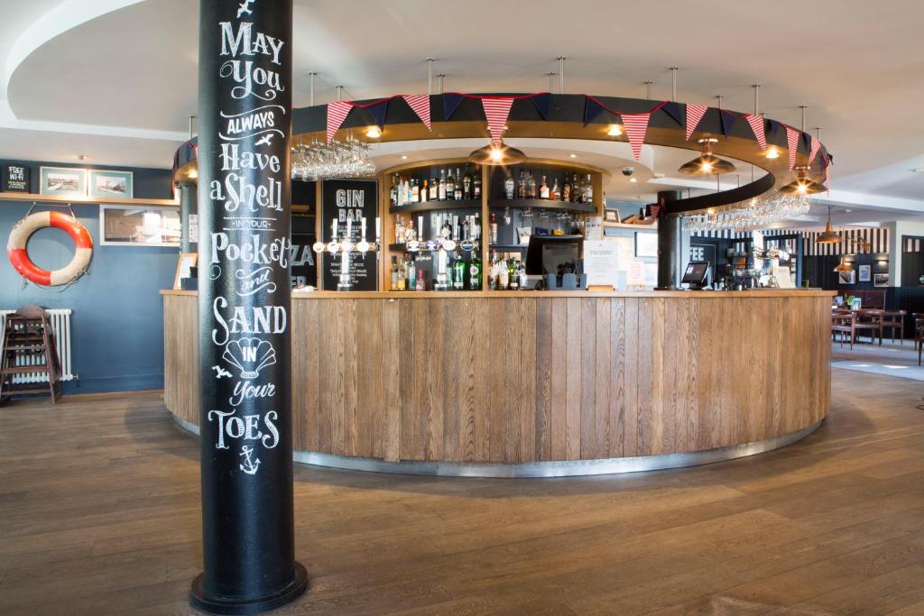 a bar with a sign in the middle of a room at Seacroft in Holyhead