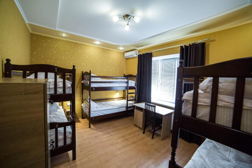 a room with three bunk beds and a window at HOLLYWOOD in Poltava