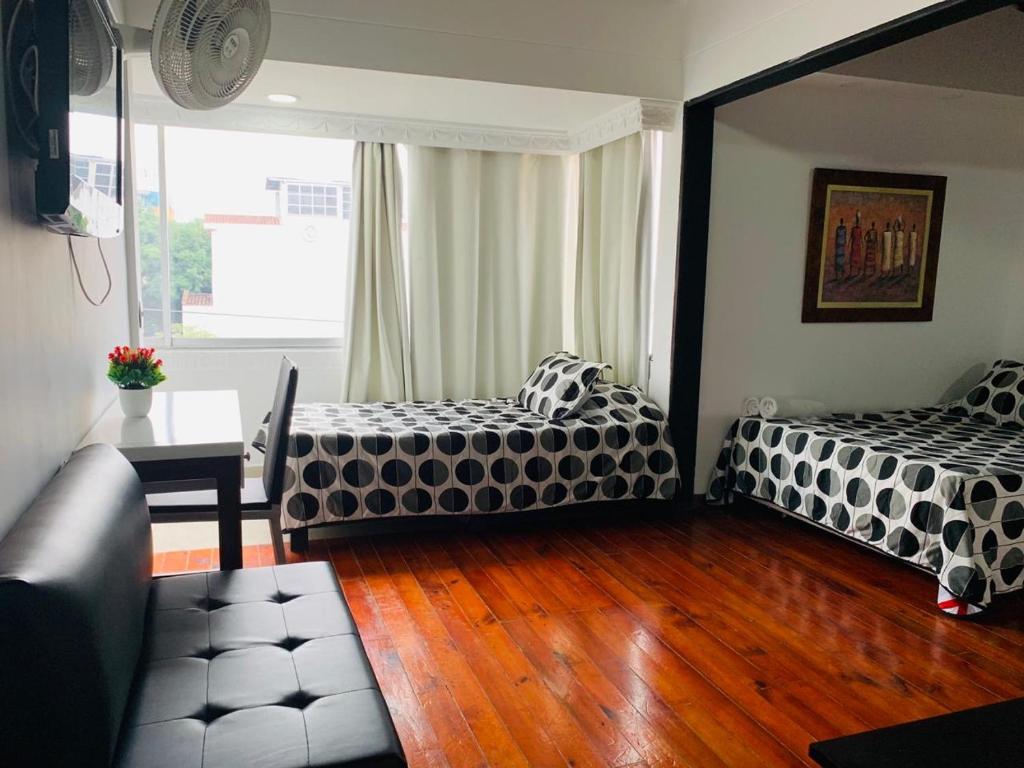 Postel nebo postele na pokoji v ubytování Hotel Lleras Premium #1