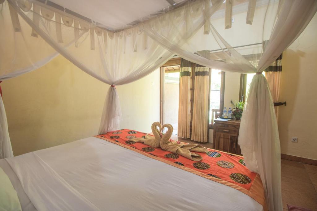 Postel nebo postele na pokoji v ubytování Trijaya Guest House Pemuteran