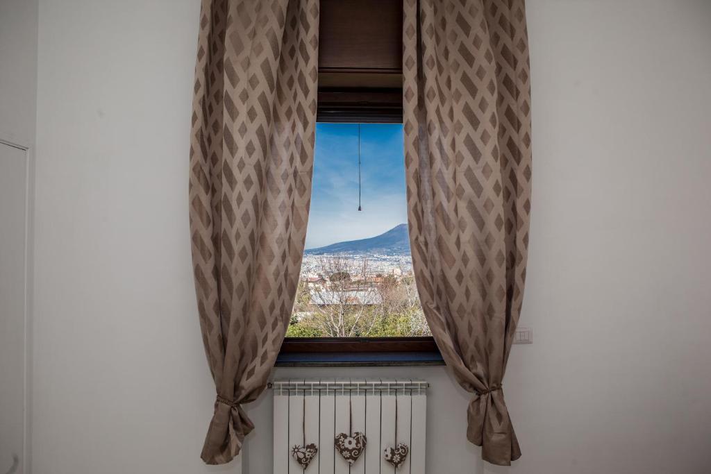 a window with a view of a mountain at Cor Mij in Gragnano