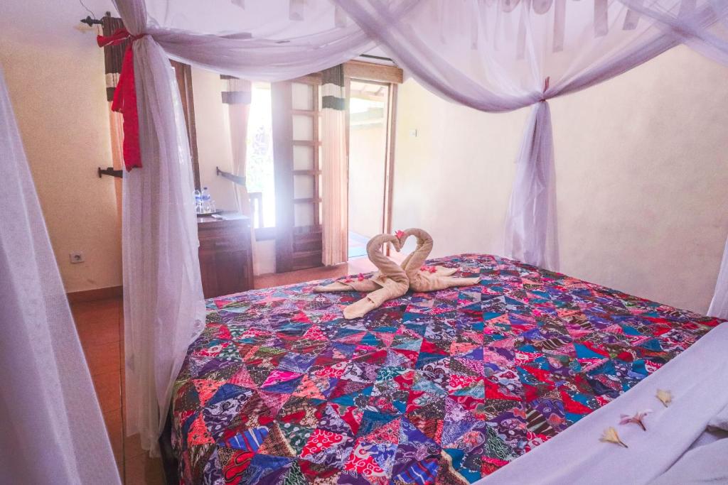 Postel nebo postele na pokoji v ubytování Trijaya Guest House Pemuteran
