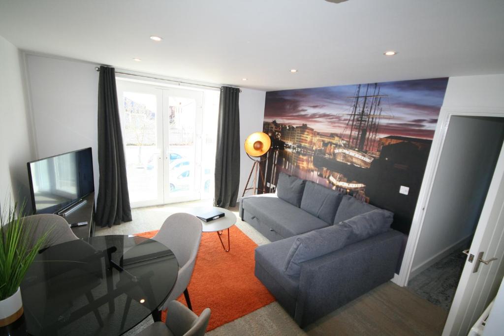 a living room with a couch and a table at Brunel Loft Apartments - YA in Bristol