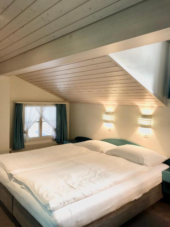 Postel nebo postele na pokoji v ubytování Hotel Châlet Du Lac