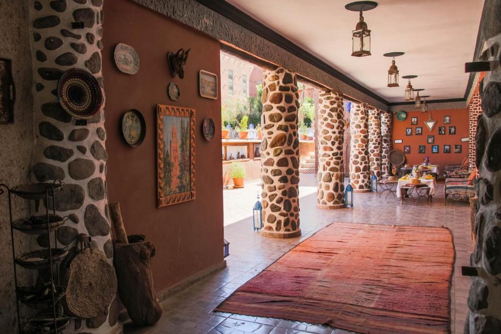 a room with a hallway with fake giraffes on the walls at Riad Malak in Ouirgane