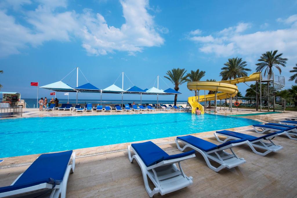 - une piscine avec des chaises et un toboggan dans l'établissement Club Hotel Rama, à Beldibi