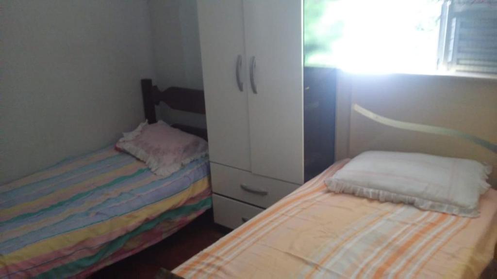 Säng eller sängar i ett rum på Aconchego dos schreiber