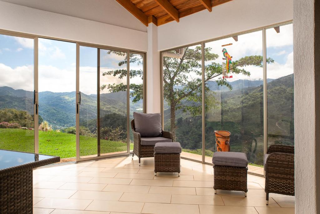 a living room with a view of the mountains at Casa Sofia, a Gem Close to Orosi Thermal Pools! in Orosí