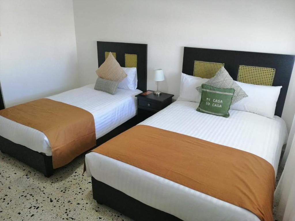 Postel nebo postele na pokoji v ubytování Múcara hotel