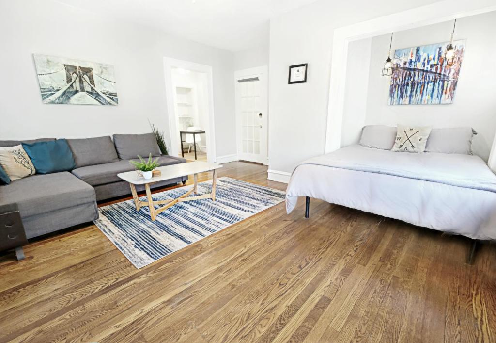 a living room with a couch and a table at The 1920s Mainstay Studio Flat on Lower Greenville in Dallas