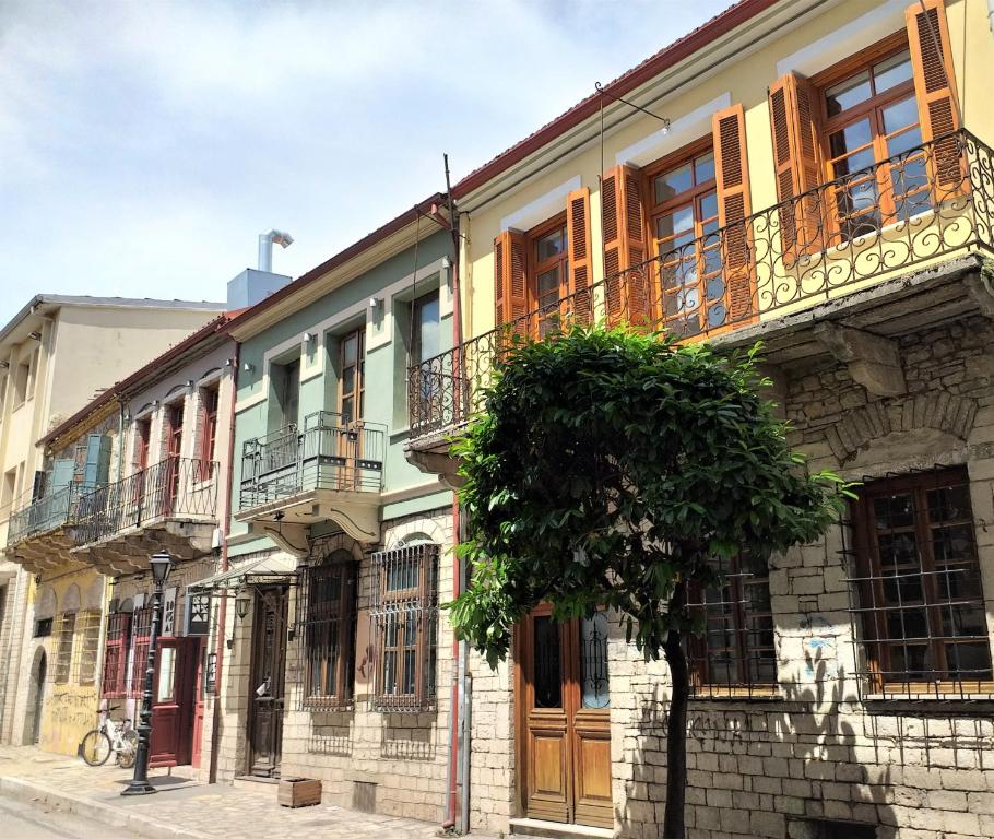 a building with a tree in front of it at Backpackers & Travelers Central old town in Ioannina