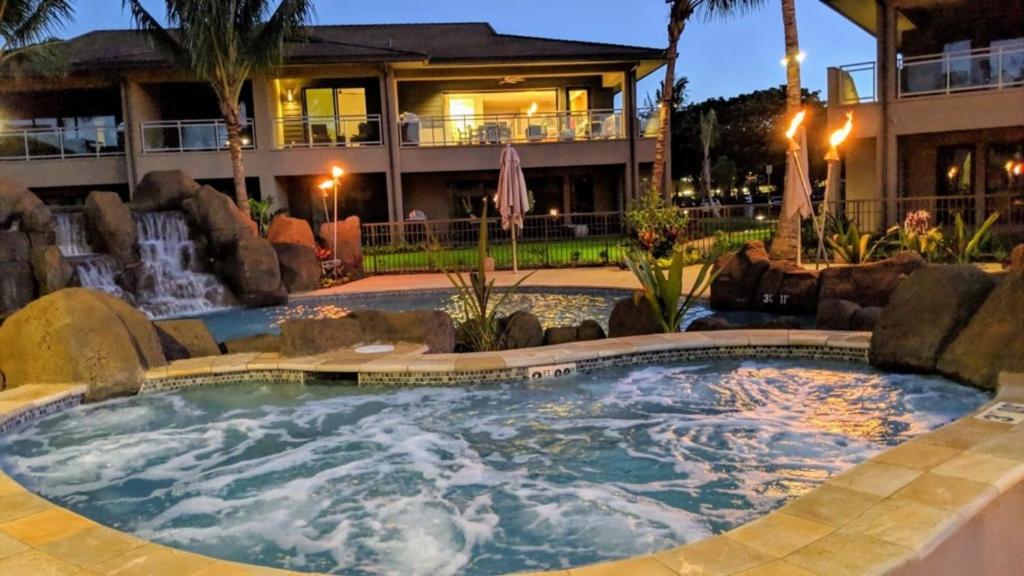 a swimming pool in a resort with a fountain at Honua kai - Luana Garden Villa 3C in Kaanapali