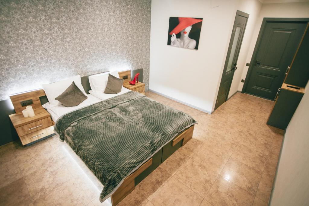 a bedroom with a large bed and a green door at 4rooms in Vinnytsya