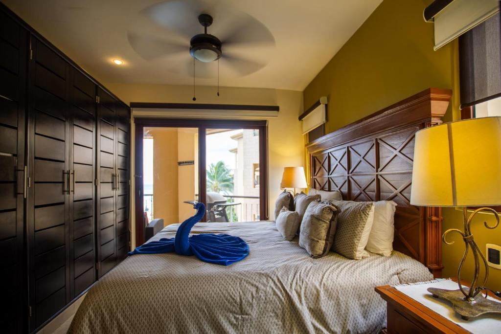 a bedroom with a large bed with a blue bird on it at El Faro 301 Coral in Playa del Carmen