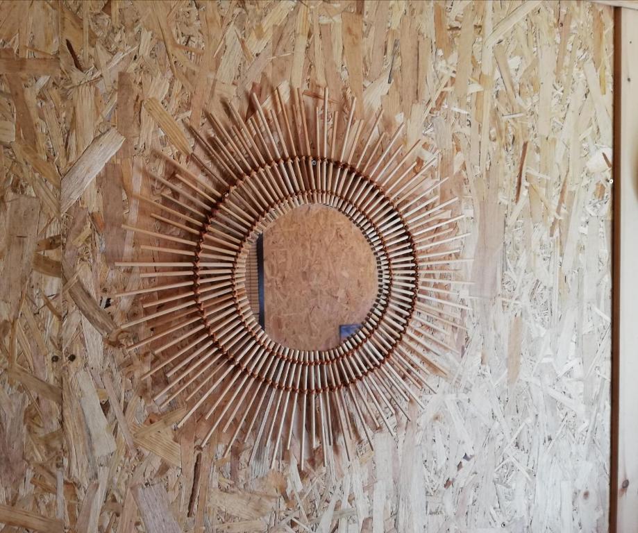 a mirror on the side of a wall at Wooden House at the Mountain-private in Paránimfoi