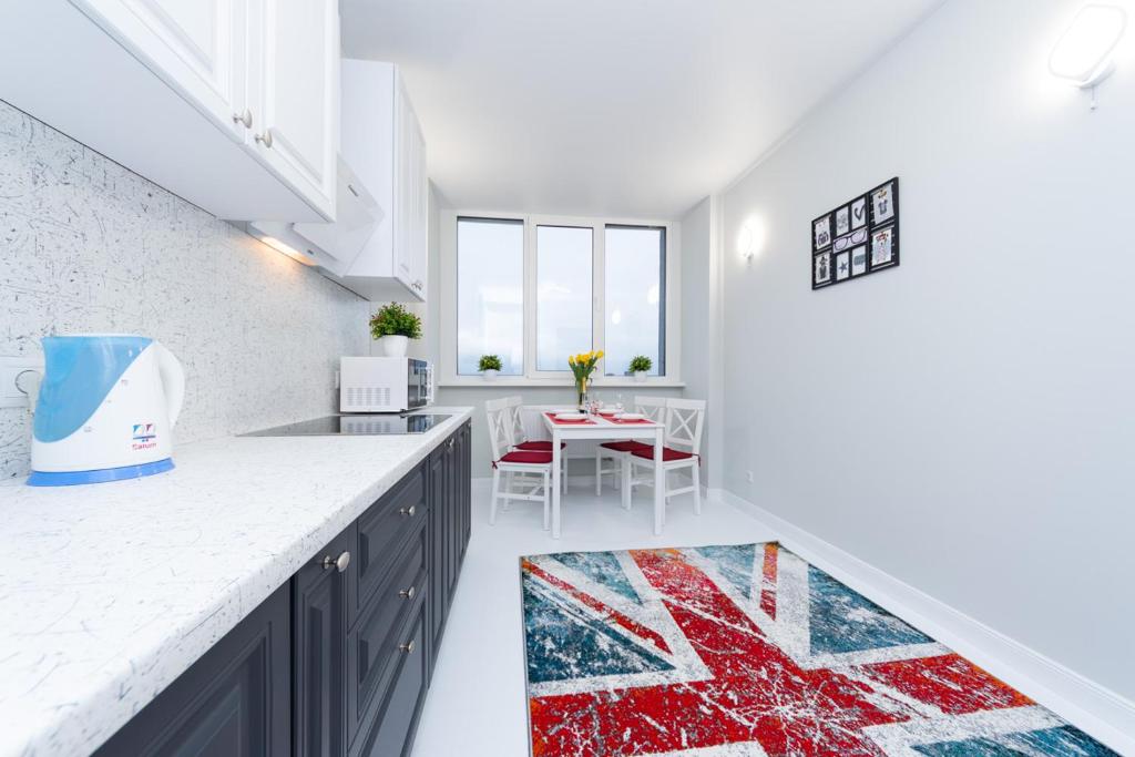a kitchen with a red white and blue rug on the floor at Уютная 1 комнатная квартира Люкс на Теремках in Kyiv