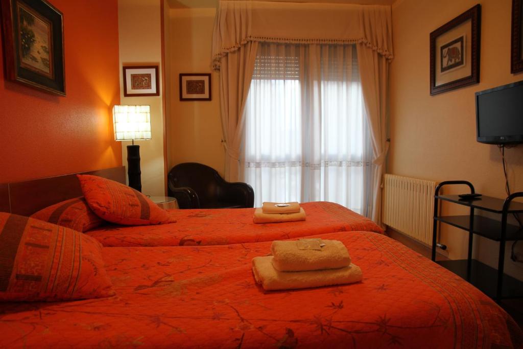 Postel nebo postele na pokoji v ubytování Hostal Acella