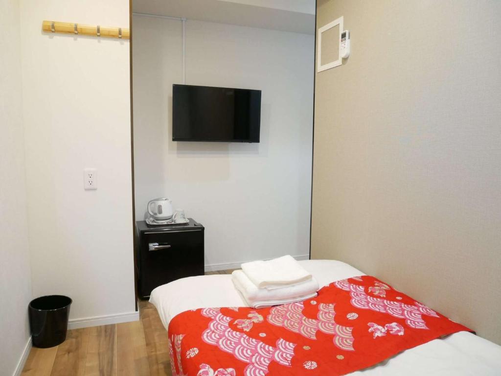 Postel nebo postele na pokoji v ubytování Tokyo shinjukutei Hotel Asahi gruop 東京新宿亭ホテル