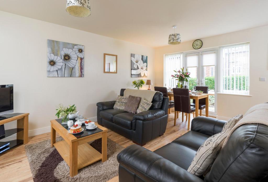 a living room with a couch and a table at Sunny Corner Cottage in Filey