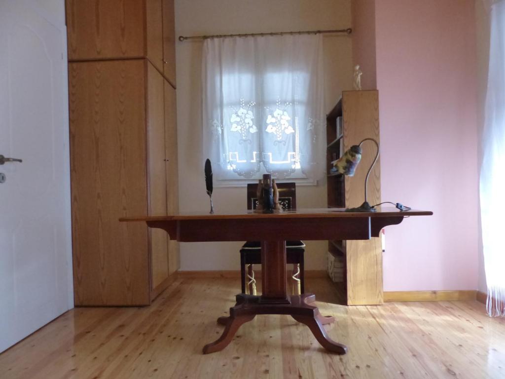 a wooden table in a room with a window at The Writers House in Ano Pavliana in Áno Pavliána